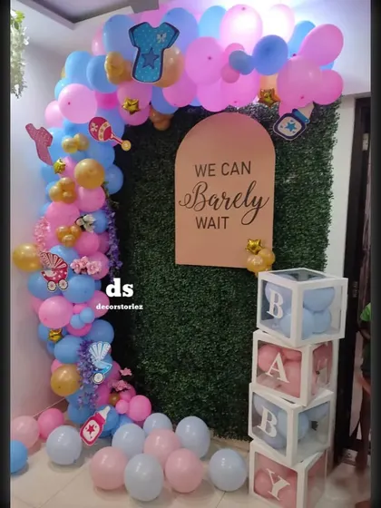 A slightly different angle of the 'We Can Barely Wait' decor, showcasing the balloon arch and transparent blocks filled with matching balloons.