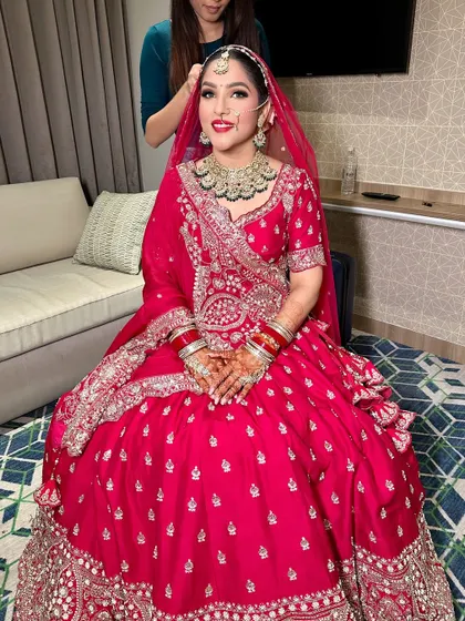 Getting the final touches done. This photo captures the complete look with the dupatta setting, showcasing the harmony between the makeup, hair, and outfit.