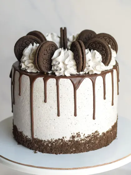 A classic Cookies & Cream birthday cake. This cake is frosted with Oreo-infused cream, features a chocolate drip, and is generously topped with whole Oreo cookies.
