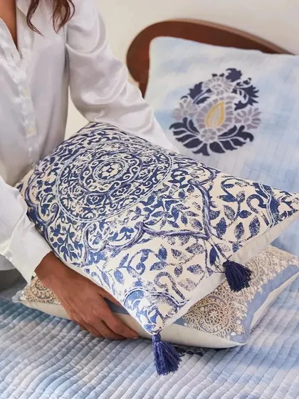 Find your cozy corner in my Indigo collection. This image showcases a stack of blue and white cushions with varied patterns, from block prints to delicate embroidery, perfect for mixing and matching.