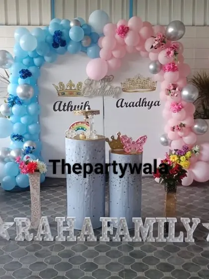 A pink and blue theme with a 'Happy Birthday' sign, perfect for a joint celebration.