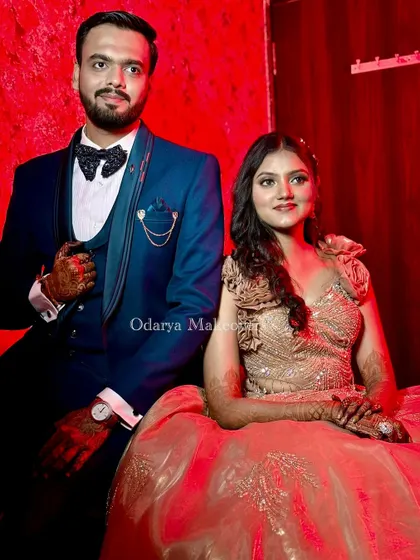 The perfect power couple portrait. Her glamorous makeup and hairstyle perfectly match his dapper suit, creating a cohesive and stylish look for their reception.