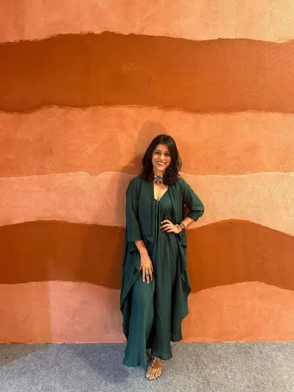 I love how this green dress flows. It's a perfect example of an outfit that is both comfortable and stylish, suitable for a day at an art gallery or a casual brunch.