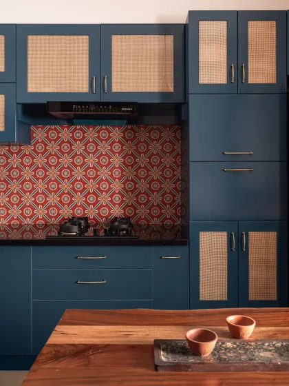 This kitchen is a whisper of South India, with its deep monsoon blues, terracotta-patterned tiles, and natural cane shutters. It’s a space designed with quiet strength, holding fast to what endures rather than chasing trends.