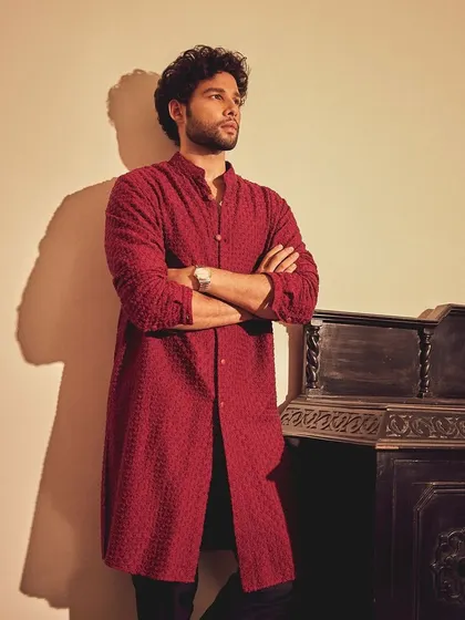 A confident pose from Siddhant. This look is all about making a statement with color and texture.