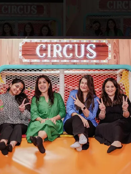 A group of moms having fun and posing for a picture in the play area.