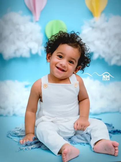This little guy's curly hair and happy smile are the stars of this hot air balloon session. We love capturing these joyful moments.