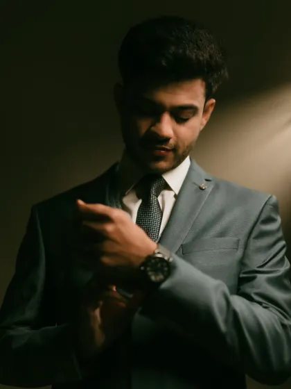 A stylish portrait of the groom, Vishnu, adjusting his cufflinks before the reception.