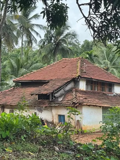 A traditional Malnad house with a tiled roof, nestled amidst the greenery. This is the kind of authentic accommodation we provide.