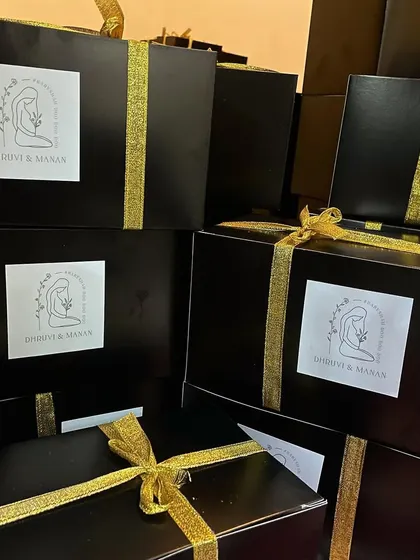 We also create elegant, high-end baby announcement hampers, like these black boxes with gold ribbons and custom labels.