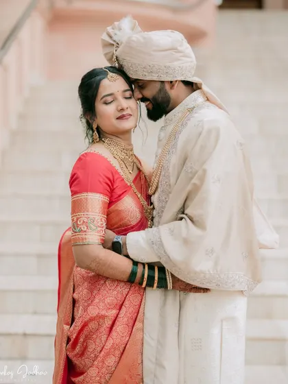 A tender moment between Sanket and Ruchi on the steps of the Mahesh Sanskritik Bhavan.