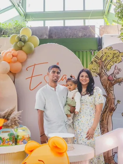 A sweet family photo from Eshan's Winnie the Pooh "Bee ONE!" party.