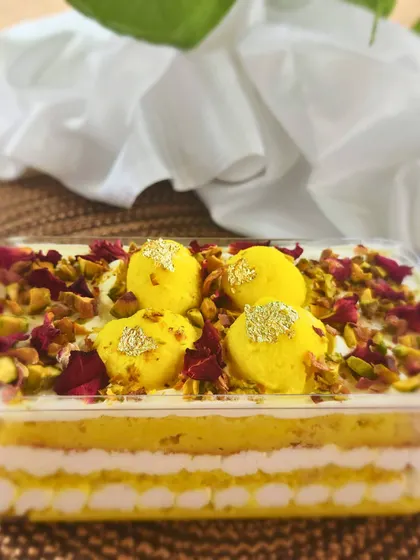 Experience my signature Rasmalai Cake in a convenient, luxurious format with these cake tubs. Each tub has layers of saffron sponge, creamy rabdi, and soft rasgulla, garnished with pistachios and rose petals for a spoonful of joy.