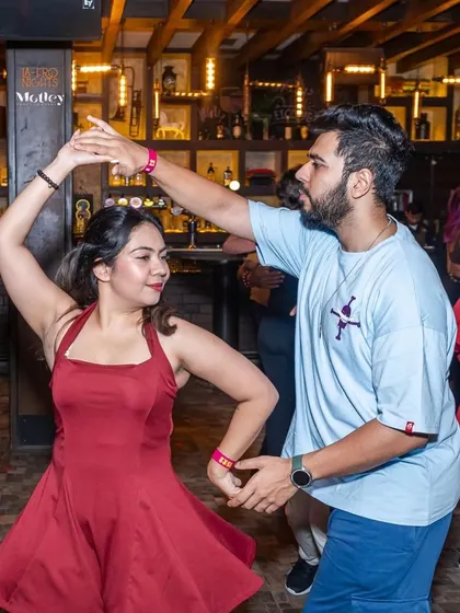 A beautiful dance moment captured at our weekly social. The red dress and the smooth turn make for a perfect picture of Salsa fun.