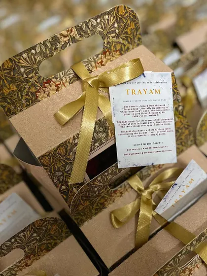 Custom hampers created for a grand naming ceremony. The elegant packaging and personalized tag make for a truly special return gift for guests.