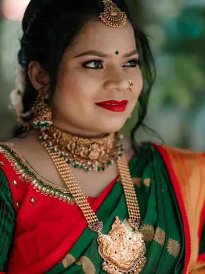 This mom-to-be is glowing in a classic temple jewellery set for her baby shower. The antique gold choker and haram add a touch of tradition to her celebration.