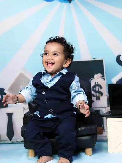This little executive is laughing with joy in his miniature office. We aim for fun and genuine expressions.