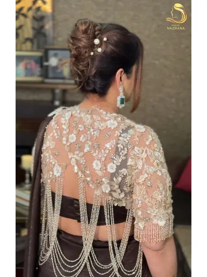 The back view of the French twist, showing the elegant lines and the subtle shimmer of the pearl accessories.