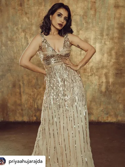 A confident and powerful stance. This look, combining a sequin gown with bold makeup, is perfect for an editorial or party.