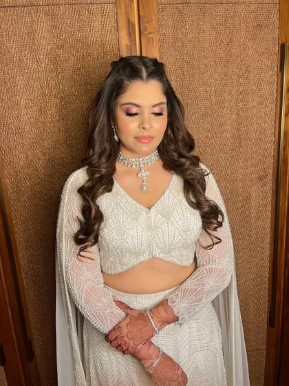 A vision in white for Simran's reception. I created a soft pink smokey eye to add a touch of color to her all-white, pearl-encrusted lehenga.