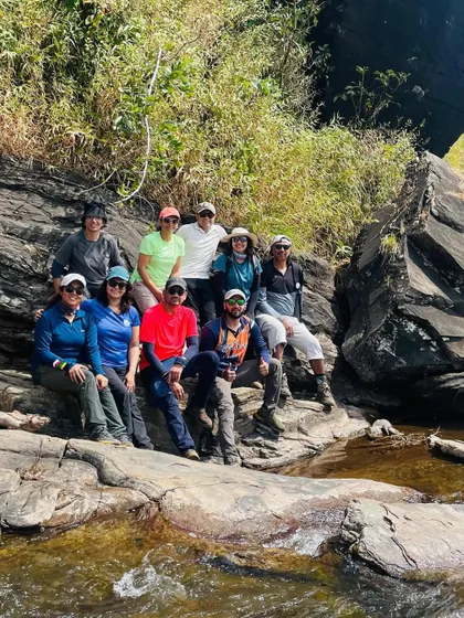 Taking a break by a stream during the Bandaje trek. These moments allow the team to rest, rehydrate, and connect with the natural beauty around them.