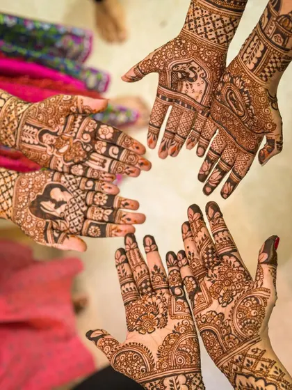 A lovely group shot showing the coordinated mehendi for the bride and her family members.