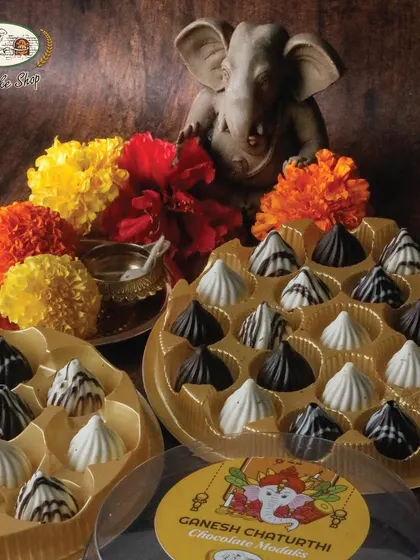 Our chocolate modaks are ready to bring sweetness to your celebrations. This image shows both the 11-piece and 21-piece boxes, perfect for families of any size.