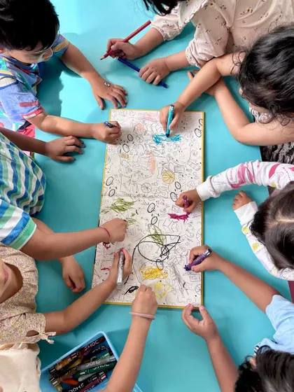 Collaborative art is a beautiful way to learn and play together. During a book reading of "The Little Book of Indian Dogs," the children gathered around to color in the beautifully illustrated endpapers, each adding their own creative touch.