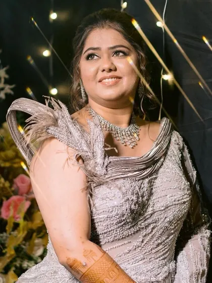 A dreamy, glamorous shot against a backdrop of fairy lights. Her makeup is designed to catch the light beautifully.