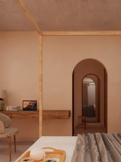 This bedroom features a simple floating desk and a woven chair, creating a functional workspace without cluttering the room. The arched doorway adds a soft architectural detail that is characteristic of my Japandi-inspired designs.
