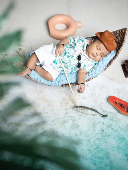 This little fisherman has fallen asleep on the job, dreaming of his next big catch.