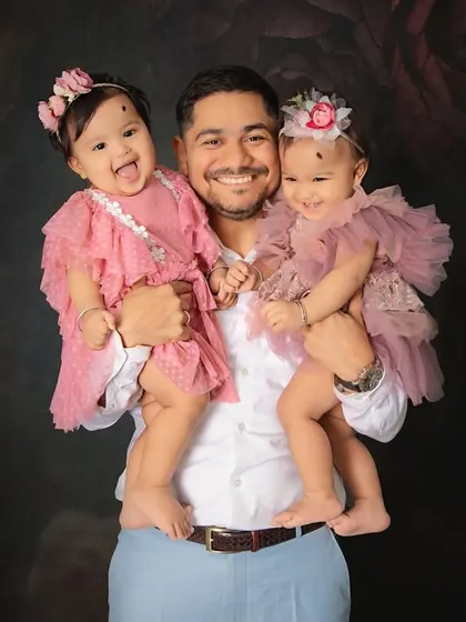 A father's love for his twin daughters shines so brightly in this portrait. Capturing these strong, gentle bonds is one of the most rewarding parts of my job.