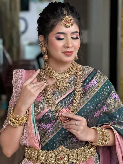 A close-up on the eye makeup and lip color choice for this traditional look, created during a pro batch class.