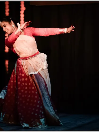 A full body shot of the dancer in motion, capturing the elegance of the art form.