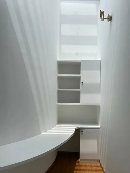 An in-progress shot of the curved, skylit study nook, showing the clean forms and the way light washes over the white surfaces.