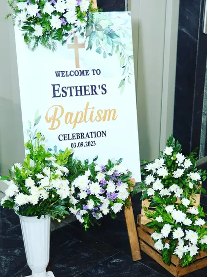 A simple and beautiful floral welcome sign for Esther's Baptism celebration. We used fresh white and purple flowers to create a warm and inviting entrance for the guests.