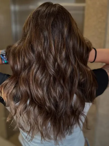 The final result of a color that feels like a superpower. This after shot shows a rich, healthy, and dimensional brunette transformation.