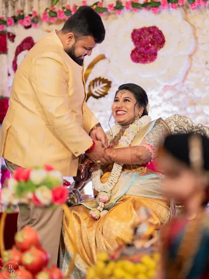A candid moment of pure happiness during a Seemantha ceremony, as the husband lovingly interacts with his wife.
