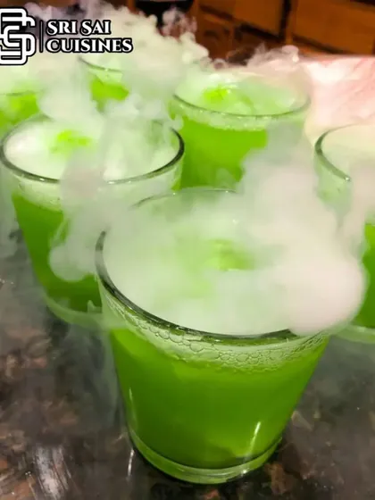 A vibrant green mocktail gets the smoky treatment. The dry ice effect works beautifully with any color, adding a layer of mystery and excitement to the drink presentation.