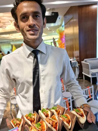 One of our friendly staff members serving up delicious mini tacos. We ensure the service at kids' parties is just as professional and warm as at any of our other events.