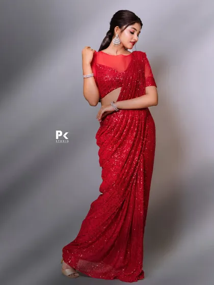A full-length view of a dazzling red sequin saree, designed to make you the star of any event.