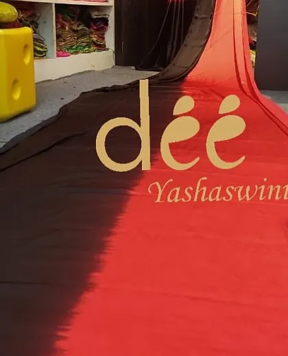 A close-up of our red and black ombre long trail saree, a unique and bold choice for photoshoots.