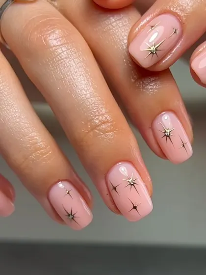 Simple yet magical, this design features tiny starbursts on a sheer pink base. It's a minimalist way to add a bit of sparkle and whimsy to your nails.