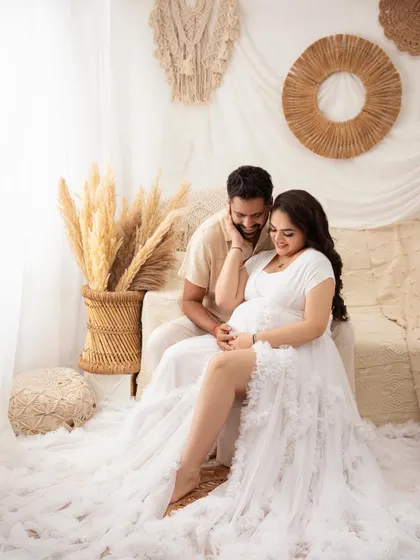 A playful and tender moment. Capturing these natural interactions is what makes a couple's maternity session so special.