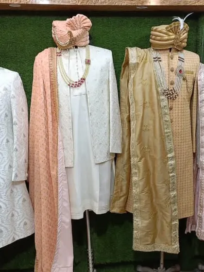Just a glimpse of the variety I keep in my store. This is a lineup of some of our ready-to-wear sherwanis in different colors and fabrics, from rich reds to elegant whites and golds, each with its own unique work.