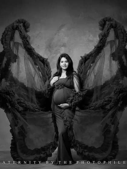 A dramatic black and white studio shot with the butterfly wings, creating a powerful and artistic statement.