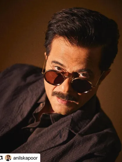 An intense close-up of Anil Kapoor. The hair is styled to be neat but with natural texture.