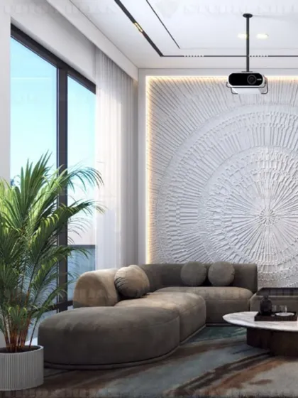 This view of the Kirti Nagar lounge highlights a beautiful textured art wall, which adds a tactile and visual focal point to the minimalist space.