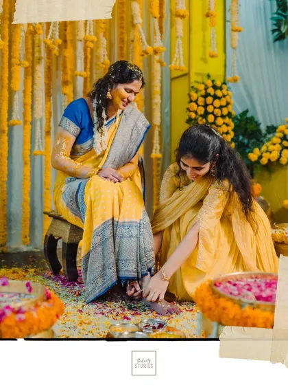 A heartwarming moment as a family member helps the bride with her anklet during the Haldi ceremony.