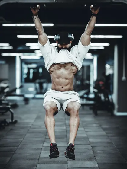 Performing a hanging ab check. A strong, visible core is not just for show; it's essential for stability and strength in all your major lifts.